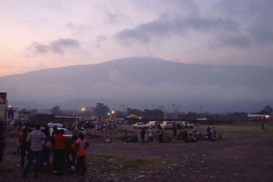 The King of Mountains: At sunset the night before the race, the winds shift and reveal Mount Cameroon to the onlookers in Molyko stadium. The true summit is on the opposite side of the mountain.