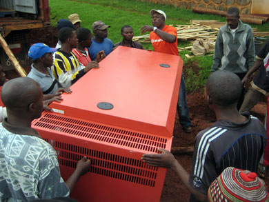 Although he holds a management position, Bannyuy is not above hard manual labor. Here, he coordinates fellow workers on moving a large generator onto HIC property.