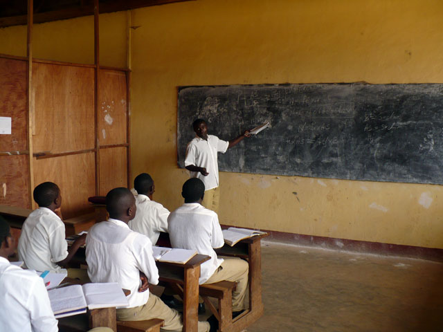 Devin, 24, solves a problem in front of the class. He hopes to attend university in Yaoundé and become a civil engineer.